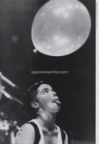 japanese magazine pinup photo of Bjork sticking out tongue while looking up at balloon